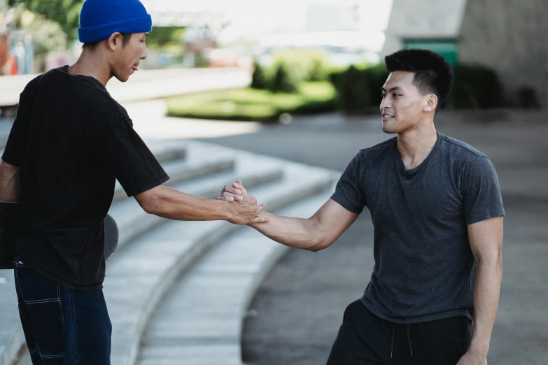 a couple of men standing next to each other, pexels contest winner, happening, fist training, lee griggs and jason chan, hoang lap, reaching out to each other