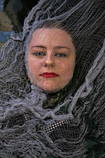 a close up of a person wearing a veil, inspired by Dora Maar, net art, detailed entangled fibres, nets and boats, photo taken in 2 0 2 0, slightly smiling