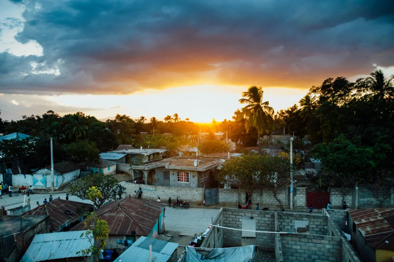 the sun is setting over a small town, pexels contest winner, colors of jamaica, thumbnail, wide high angle view, sun lit