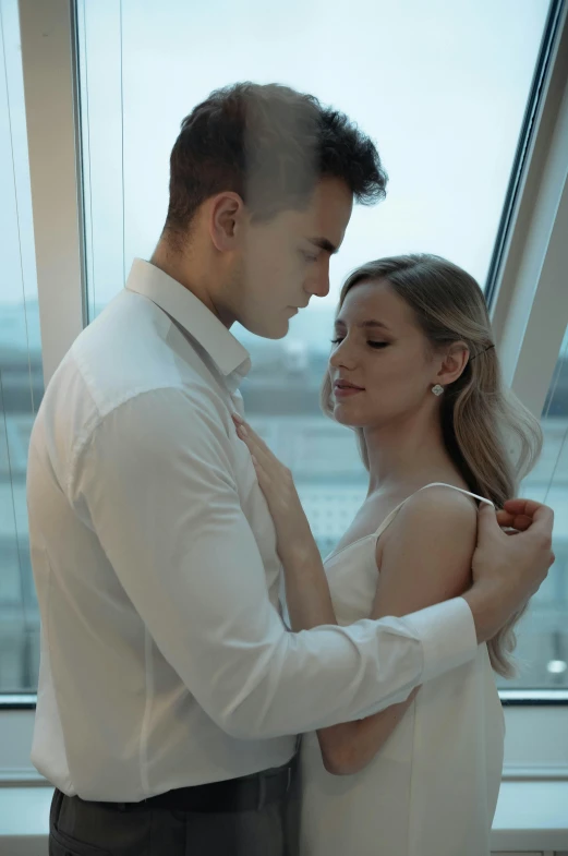 a man and a woman standing next to each other, pexels contest winner, romanticism, low quality video, penthouse, wearing white shirt, daniil kudriavtsev