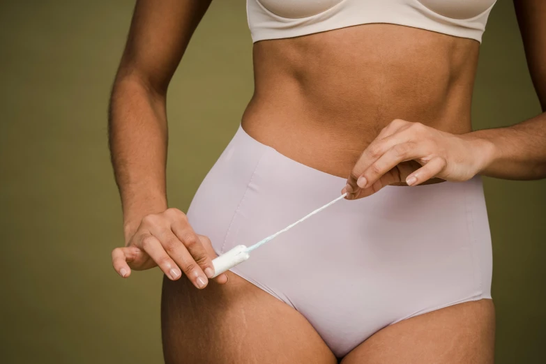 a close up of a person in underwear holding a toothbrush, by Nina Hamnett, plasticien, manuka, physical : tinyest midriff ever, grey, thigh gap