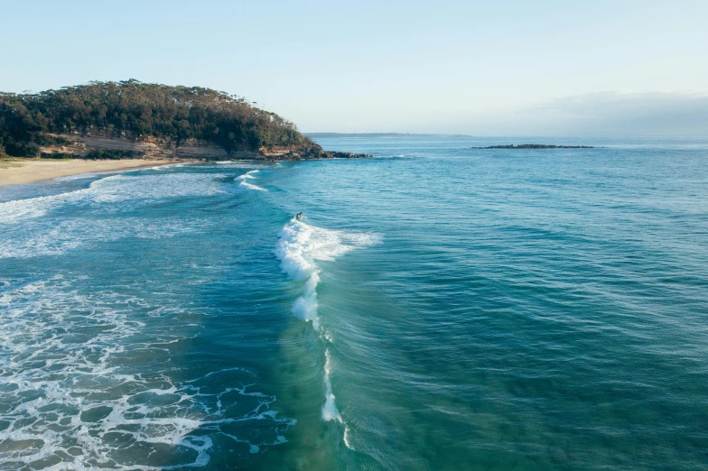 a large body of water next to a sandy beach, by Peter Churcher, unsplash contest winner, surfing, straya, crystal clear sea, bulli