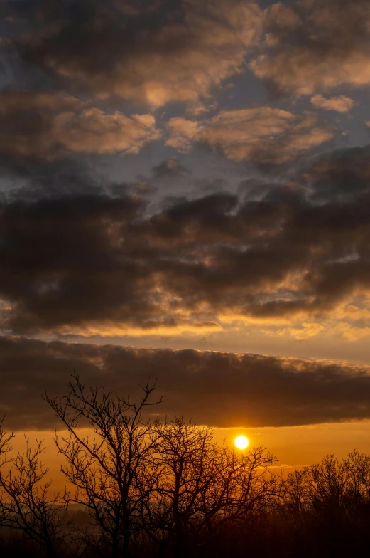 the sun is setting behind the clouds in the sky, by Jan Tengnagel, sun dappled, dramatic lighting - n 9, grey