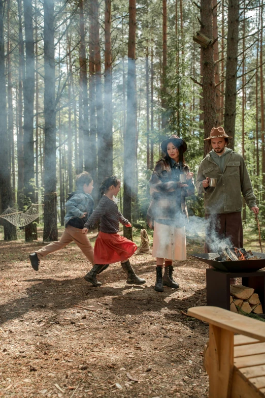 a group of people standing around a fire in the woods, fisher price redwood forest, lifestyle, hot food, action shot