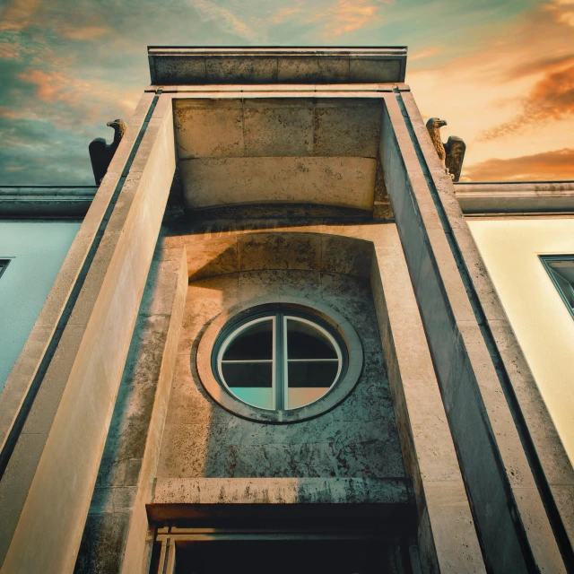 a very tall building with a round window, inspired by Giorgio de Chirico, pexels contest winner, neoclassicism, faded colors, front lit, portal to hell, golden hour closeup photo