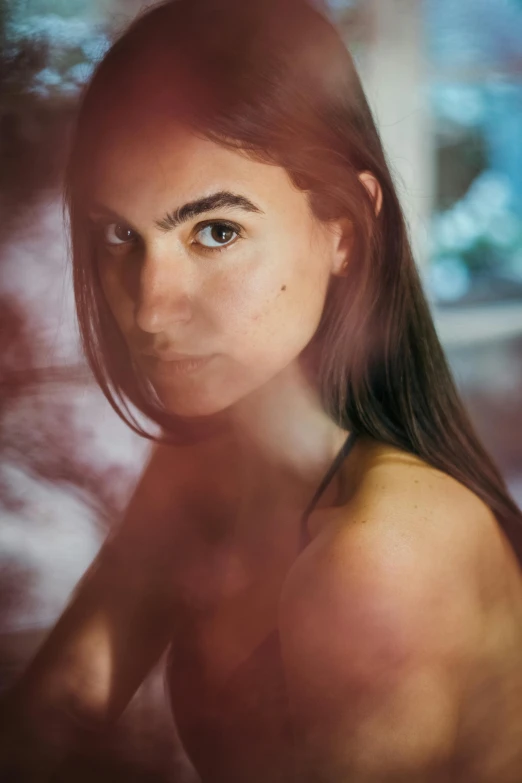 a woman posing for a picture in front of a window, inspired by Elsa Bleda, pexels contest winner, photorealism, sasha grey, backlit face, medium format, scratches on photo