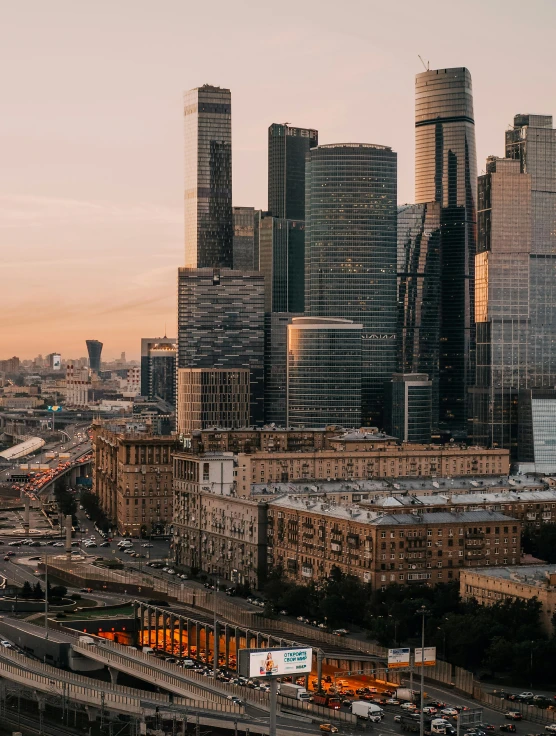 a large city filled with lots of tall buildings, pexels contest winner, socialist realism, russian architecture, warm light, header text”, overview