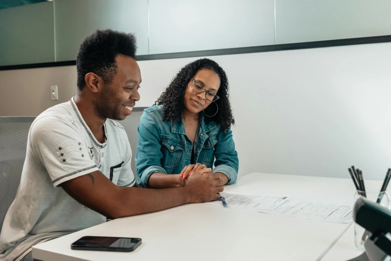 a man and a woman sitting at a table, pexels contest winner, academic art, afro tech, on a white table, background image, lachlan bailey