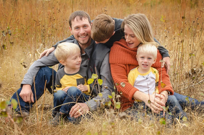 a family posing for a picture in a field, a portrait, by Carey Morris, pexels, conceptual art, avatar image, full frame image, fall season, husband wife and son