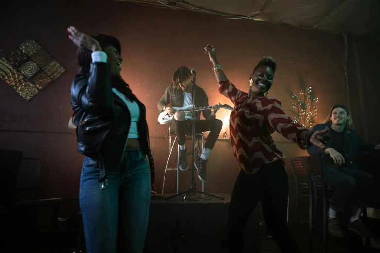 a group of people standing on top of a stage, an album cover, pexels, happening, performing a music video, indoor scene, ( ( dark skin ) ), 3 actors on stage