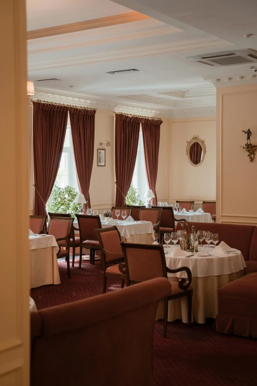 a dining room filled with lots of tables and chairs, a portrait, instagram, art nouveau, surikov, comfy ambience, draped drapes, plain view