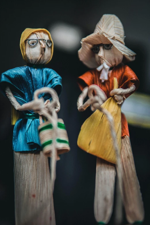 a couple of figurines standing next to each other, by Tobias Stimmer, pexels contest winner, visual art, straw, mousefolk, vibrant colour, made of wood