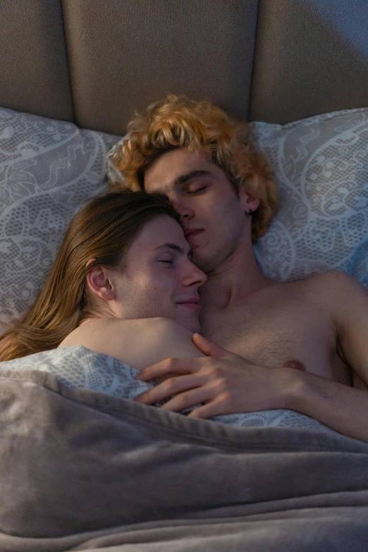 a man and woman laying in bed next to each other, featured on reddit, serial art, sophia lillis, lesbian embrace, promo image, beautiful boy