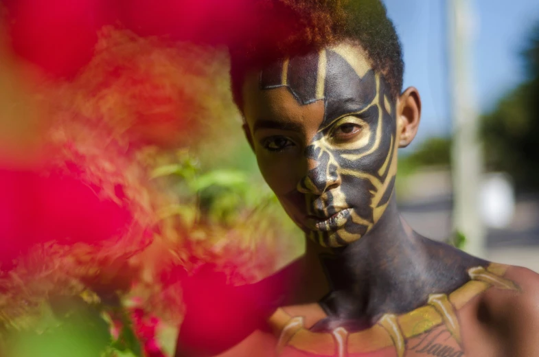 a close up of a person with a painted face, pexels contest winner, afrofuturism, flowers around, the smooth black jaguar, mkbhd as iron man, light skin