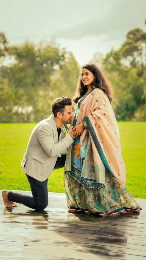 a man kneeling down next to a woman in a dress, a colorized photo, pexels contest winner, wearing a kurta, man proposing his girlfriend, 15081959 21121991 01012000 4k, profile pic