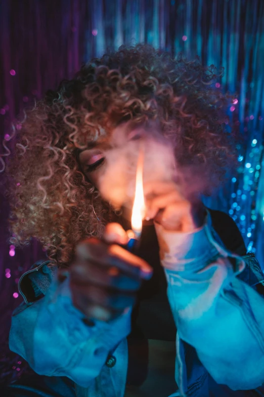 a woman holding a lit candle in front of her face, an album cover, inspired by Elsa Bleda, trending on pexels, smoking a magical bong, in a nightclub, short curly blonde haired girl, ganja