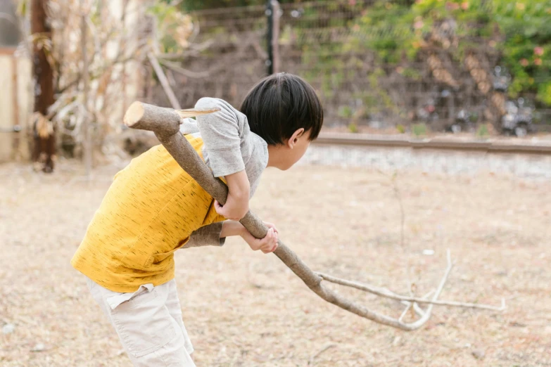 a young boy playing with a stick in a yard, inspired by Baiōken Eishun, unsplash, shin hanga, holding a giant flail, live action, narumi kakinouchi, 🦩🪐🐞👩🏻🦳