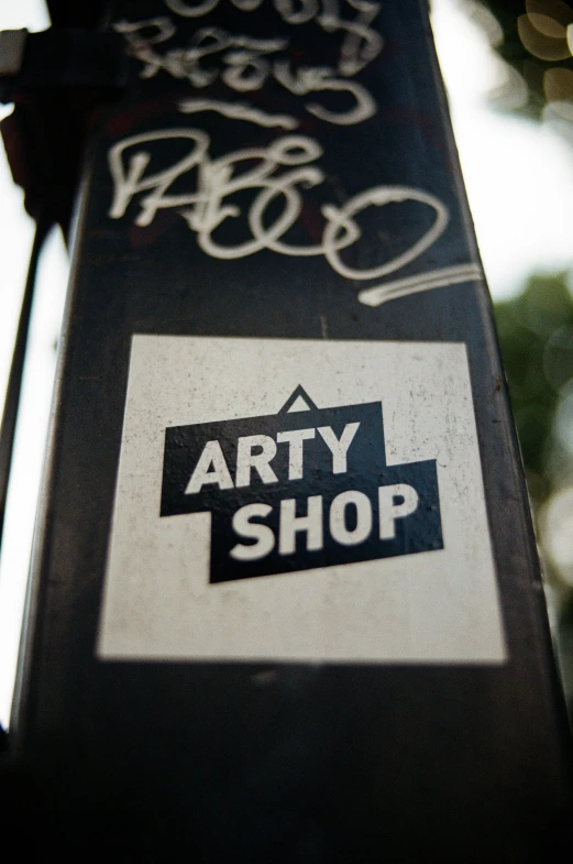 a close up of a street sign with graffiti on it, by Oskar Lüthy, graffiti, shop front, ary scheffer, art stand, best of art station