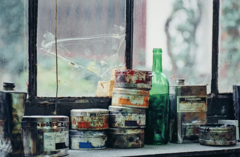 a bunch of paint cans sitting on a window sill, a still life, pexels contest winner, arte povera, jar on a shelf, mineral collections, promo image