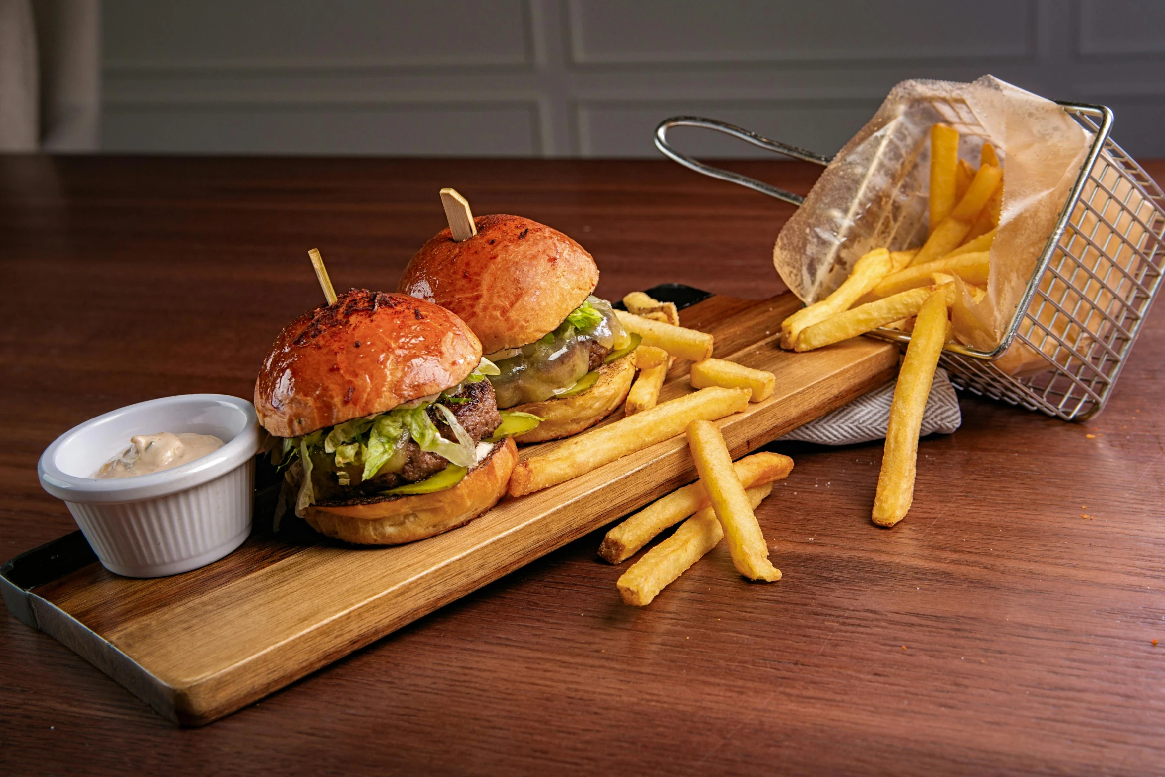 a wooden cutting board topped with a sandwich and french fries, a portrait, unsplash, photorealism, adult pair of twins, crispy buns, fine dining, low - angle shot