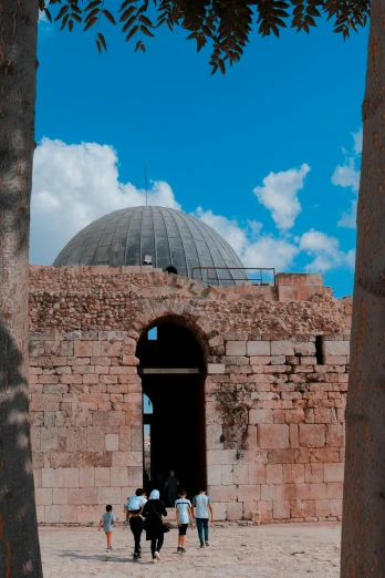 a group of people walking in front of a building, dau-al-set, inside a dome, epic vista of old ruins, blue sky, instagram story