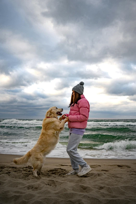 a woman is playing with a dog on the beach, pexels contest winner, renaissance, overcast weather, square, 4k-, waving