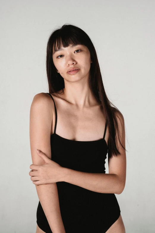 a woman in a black bodysuit posing for a picture, inspired by Kim Tschang Yeul, trending on pexels, wearing : tanktop, square facial structure, studio shoot, lily