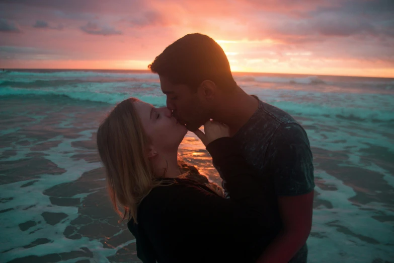 a couple kissing on the beach at sunset, pexels contest winner, attractive girl, lynn skordal, in the ocean, manly