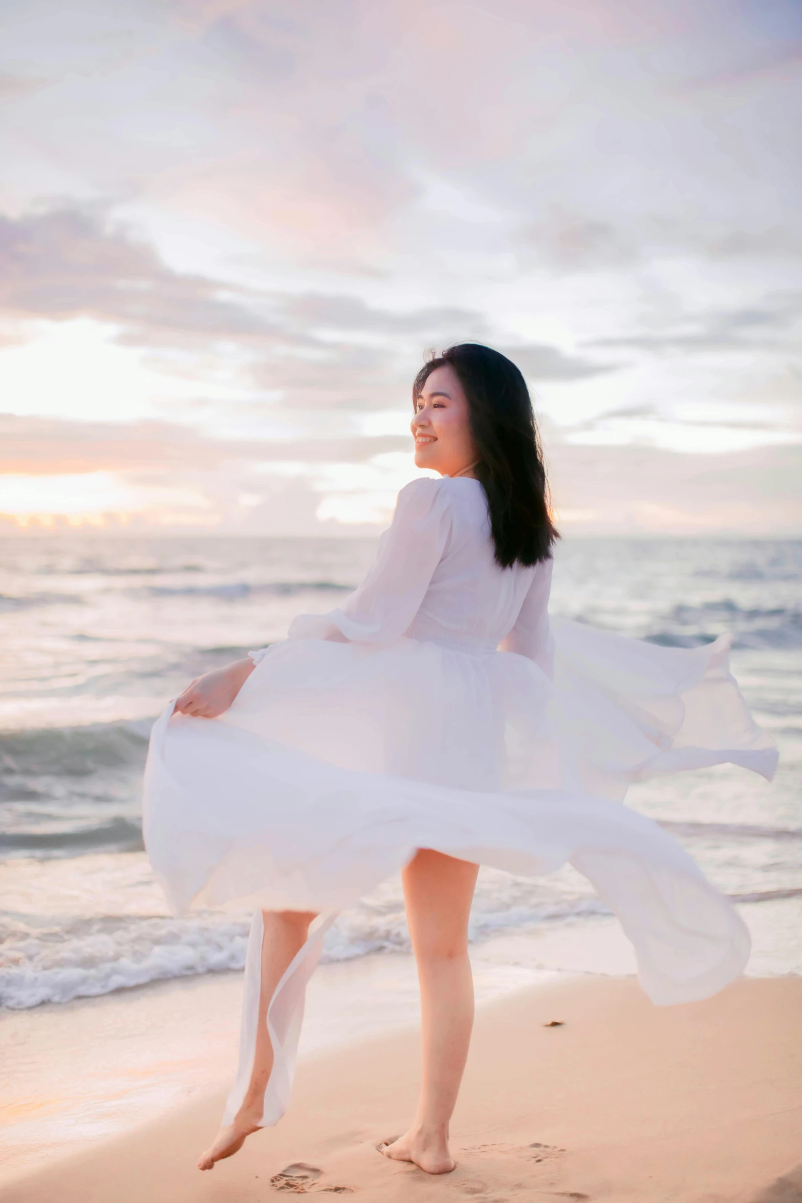 a woman in a white dress standing on a beach, inspired by Kim Du-ryang, unsplash, radiant soft light, fullbody photo, profile image, chiffon