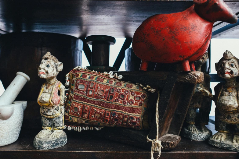 a bunch of figurines sitting on top of a shelf, a still life, unsplash, folk art, indian patterns, treasure chests, crimson accents, high details photo