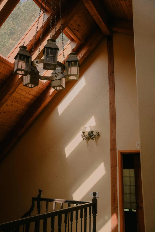 there is a light that is hanging from the ceiling, unsplash, light and space, peaceful wooden mansion, high angle shot, cabin lights, shot on sony a 7 iii