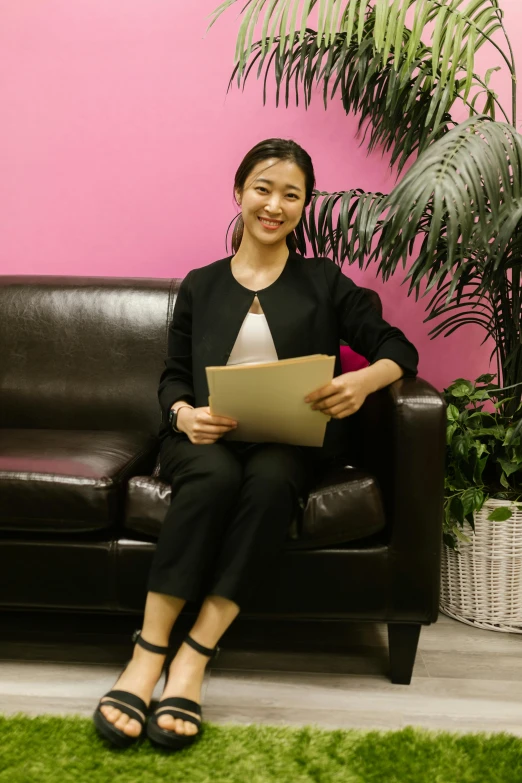 a woman sitting on a couch with a laptop, a picture, nishimiya shouko, staff, wearing business casual dress, waiting room