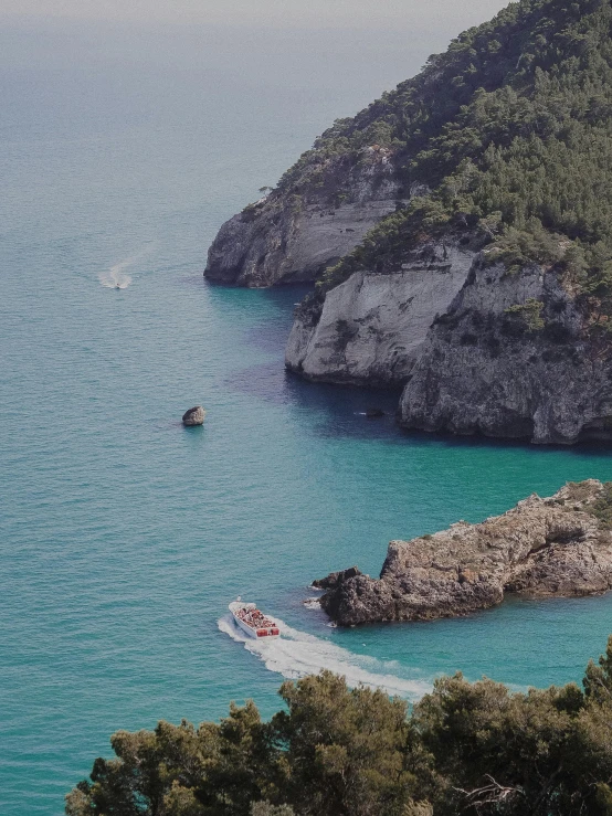 a couple of boats that are in the water, by Giuseppe Avanzi, pexels contest winner, detailed trees and cliffs, view of sea, slide show, thumbnail