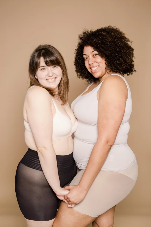 a couple of women standing next to each other, varying thickness, silicone skin, promo image, large)}]