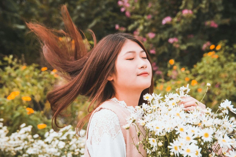 a woman holding a bunch of white flowers, by Tan Ting-pho, pexels contest winner, aestheticism, wind in long hair, aesthetic cute with flutter, profile image, having a good time