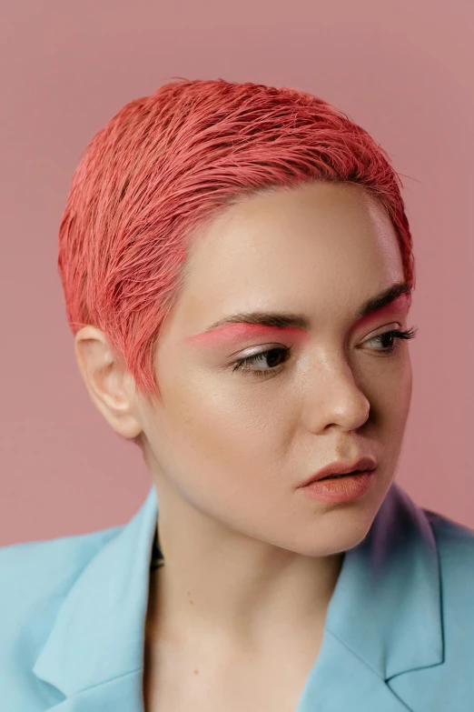 a woman with pink hair wearing a blue jacket, an album cover, inspired by Cosmo Alexander, trending on pexels, angular eyebrows, coral, kai carpenter, rosalia