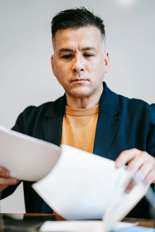 a man sitting at a table with papers in front of him, pexels contest winner, buzz cut gray hair, holding a clipboard, gif, man standing