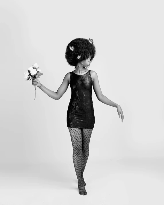 a black and white photo of a woman holding a flower, an album cover, inspired by Carrie Mae Weems, pexels contest winner, funk art, full body model, betty boop, afro, portrait of black mermaid