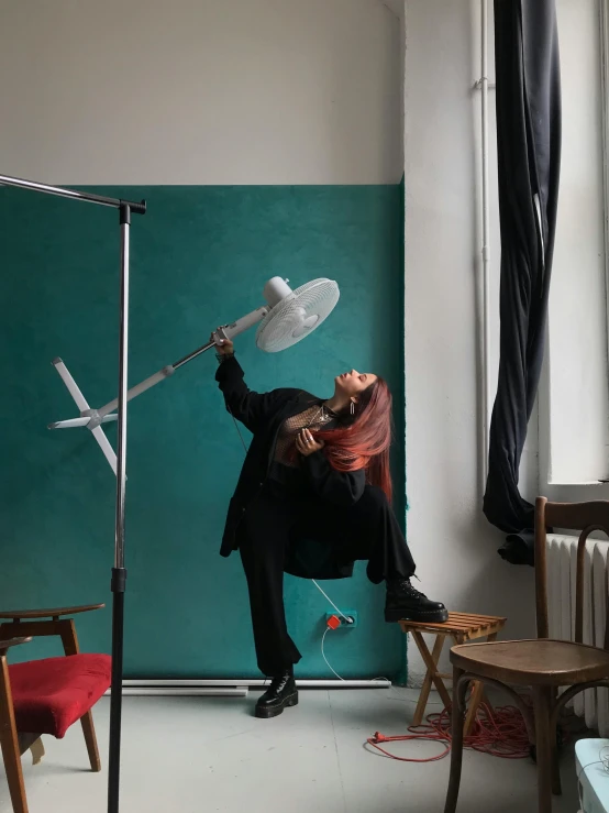 a man that is standing in a room, inspired by Annie Leibovitz, holding up a large shield, studio product shot, emerging from her lamp, photo for magazine