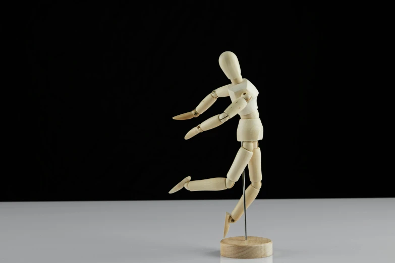 a wooden mannequin standing on a wooden base, inspired by Constantin Hansen, dancing a jig, fully posable, 1 figure only, pointè pose