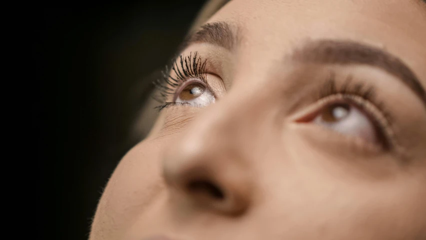 a close up of a woman with long eyelashes, trending on pexels, hurufiyya, looking upwards, 4k hyperrealistic, sideview, shot on 1 5 0 mm