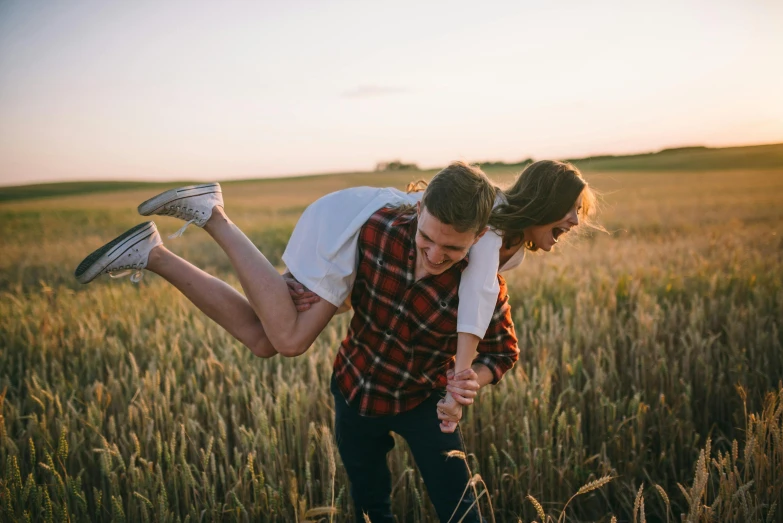 a man carrying a woman in a field, pexels contest winner, casual game, lachlan bailey, playful smile, summer evening
