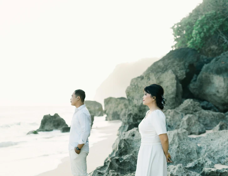 a man and a woman standing next to each other on a beach, a picture, unsplash, wedding photo, animation, indonesia, white