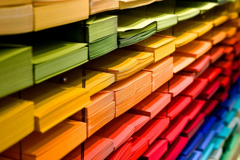 a bunch of colorful papers stacked on top of each other, by Matthias Stom, pexels, stacking supermarket shelves, youtube thumbnail, on display, sheet paper