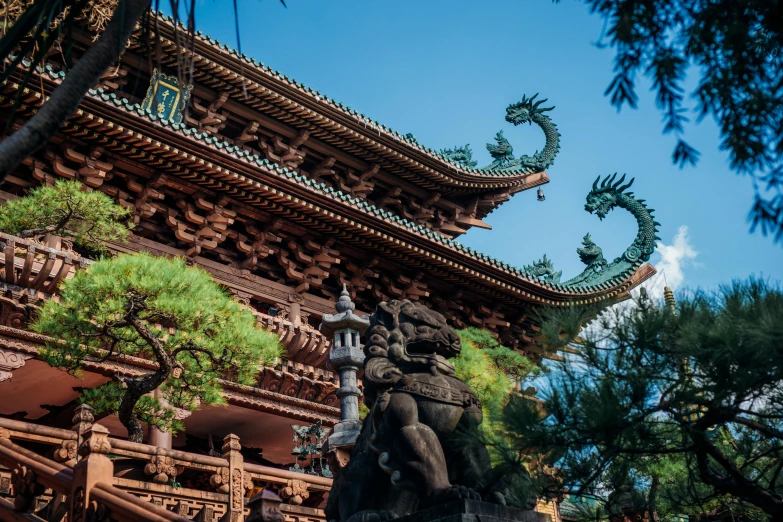 a building with a dragon statue in front of it, inspired by Itō Jakuchū, pexels contest winner, cloisonnism, zhangjiajie, avatar image, brown, archways made of lush greenery