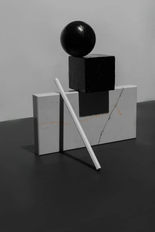 a black ball sitting on top of a white block, an abstract sculpture, inspired by Robert Mapplethorpe, unsplash, suprematism, with a straw, white on black, made of liquid metal and marble, square