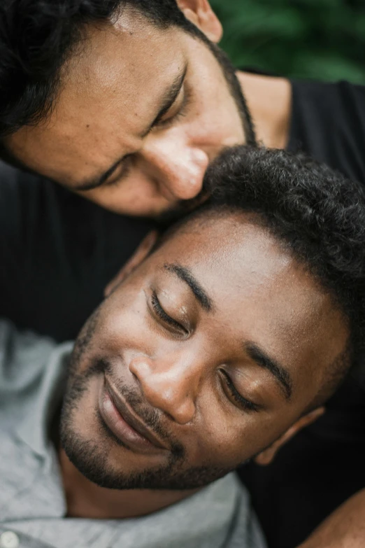 a man and a woman laying on top of each other, african facial features, two men hugging, lgbtq, close - up photograph