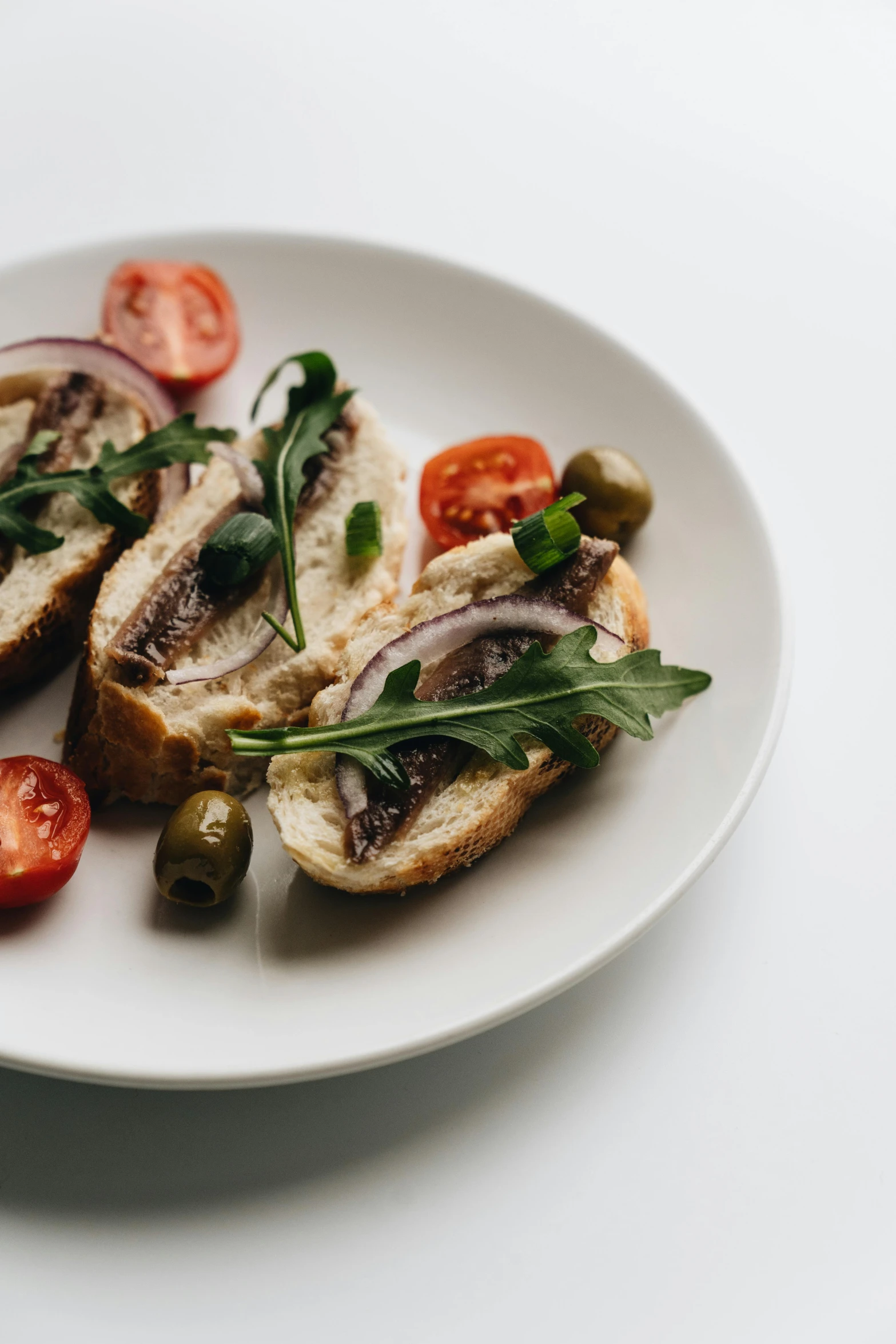 a close up of a plate of food on a table, holding a baguette, on a pale background, pro - vida, stuffed