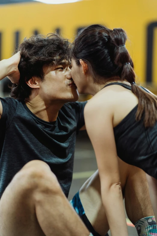 a couple of people sitting on top of a basketball court, by Wen Zhenheng, pexels contest winner, photorealism, kiss mouth to mouth, athletic crossfit build, actor, gif