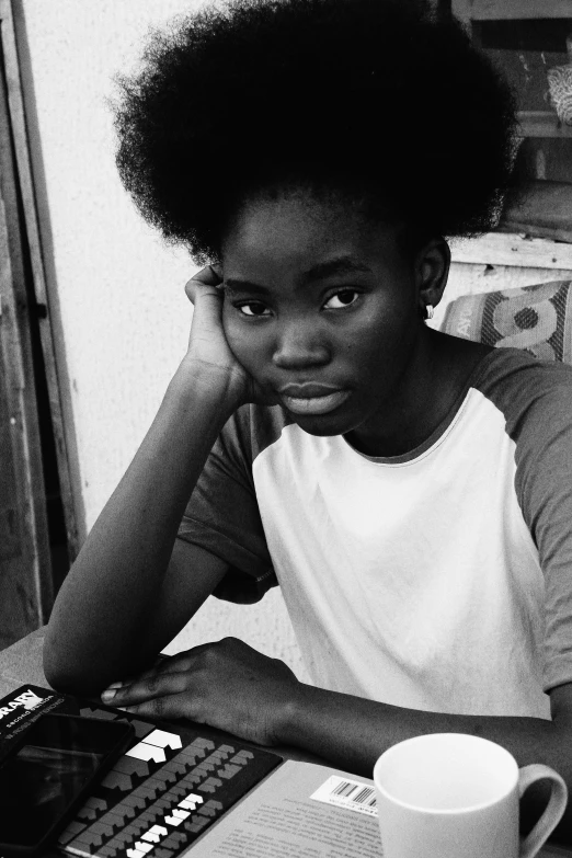 a person sitting at a table with a laptop, a black and white photo, by Nadir Afonso, afrofuturism, portrait of a young teenage girl, circa 1 9 8 4, 🤤 girl portrait, adut akech